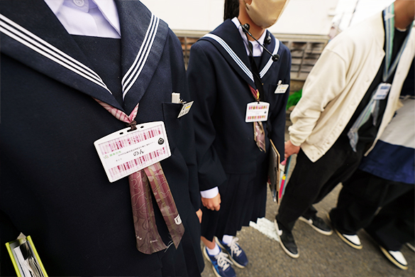 Students wearing Aizukata scarves leading tours. The scarves are worn as ribbons on their school uniforms.